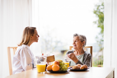 caregiver having a meal with her patient