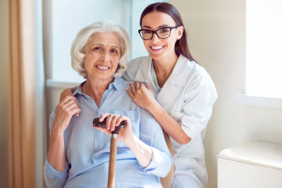 senior woman and her caregiver smiling