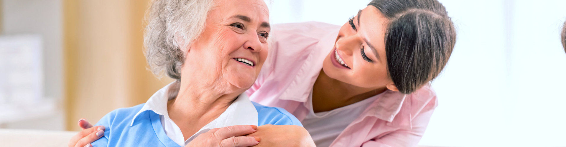 senior woman with her caregiver smiling